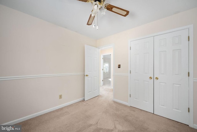 unfurnished bedroom featuring a closet, baseboards, carpet, and a ceiling fan