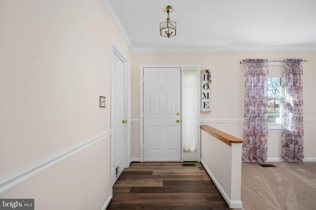 interior space featuring visible vents, ornamental molding, wood finished floors, carpet flooring, and baseboards