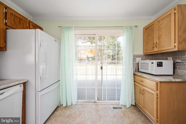 kitchen featuring decorative backsplash, white appliances, ornamental molding, and light countertops