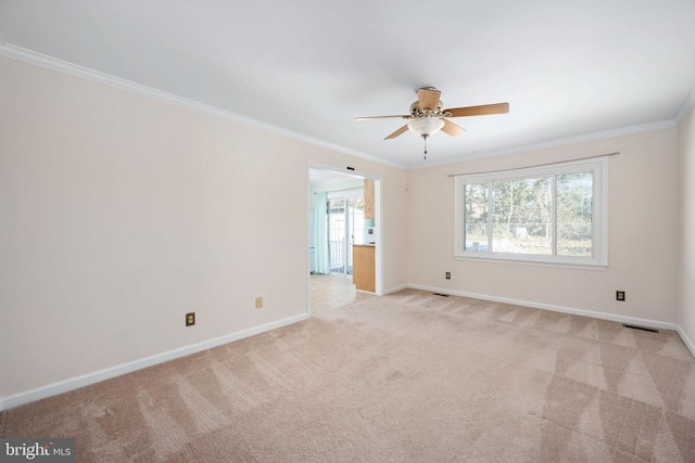 unfurnished room featuring baseboards, light colored carpet, ceiling fan, and crown molding