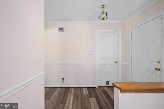 foyer entrance featuring baseboards, ornamental molding, and dark wood-style flooring