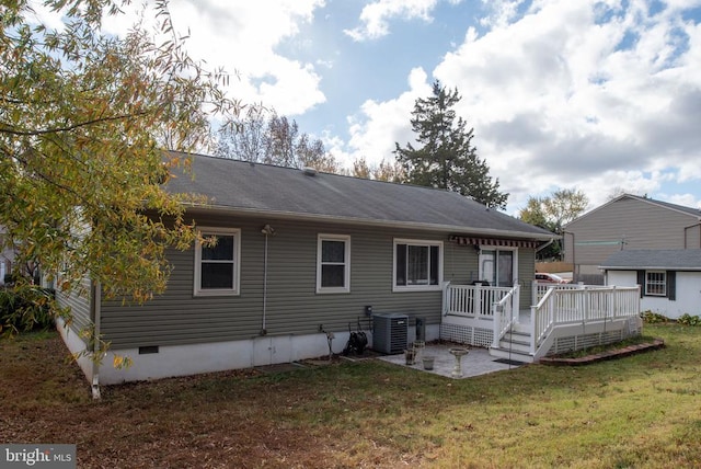 back of house featuring central AC unit, a wooden deck, a yard, crawl space, and a patio area