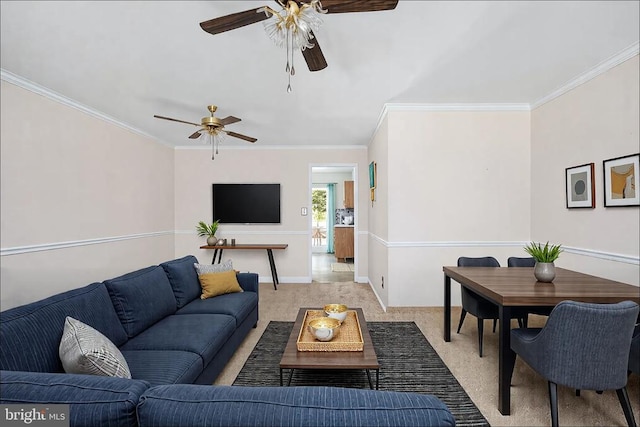 living room featuring baseboards, ornamental molding, and a ceiling fan