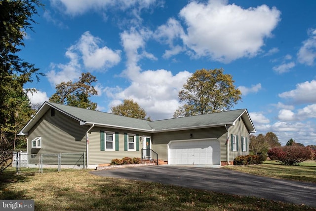 ranch-style home with a front lawn, aphalt driveway, fence, an attached garage, and crawl space