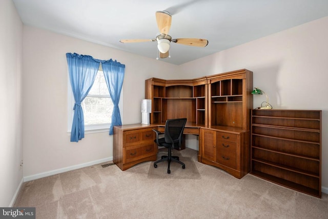 office area with ceiling fan, visible vents, baseboards, and light carpet