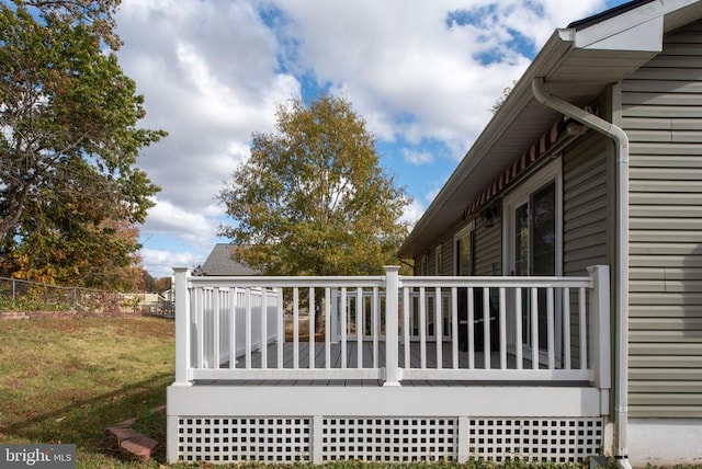 deck featuring a yard and fence