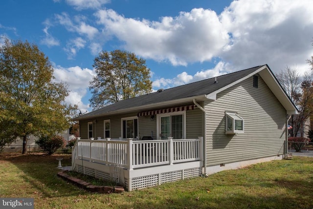 view of front of property with a deck, a front yard, and crawl space