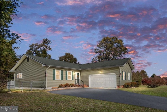 ranch-style house with fence, driveway, an attached garage, a yard, and crawl space