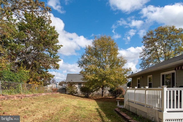 view of yard with a deck and fence