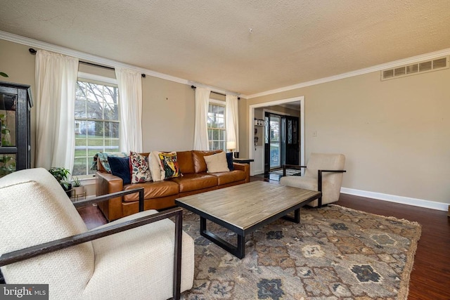 living room featuring wood finished floors, ornamental molding, baseboards, and a textured ceiling