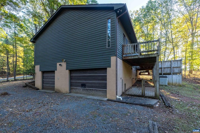210 Pasture Ln, Stanardsville, VA 22973 - view of side of property with a garage, a wooden deck, and driveway