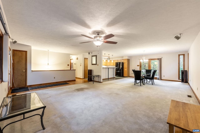 210 Pasture Ln, Stanardsville, VA 22973 - living area with baseboards, a textured ceiling, ceiling fan with notable chandelier, and light colored carpet