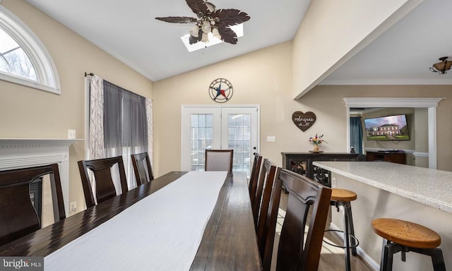 5819 Telluride Ln, Spotsylvania, VA 22553 - dining area with plenty of natural light, a glass covered fireplace, ceiling fan, wood finished floors, and lofted ceiling