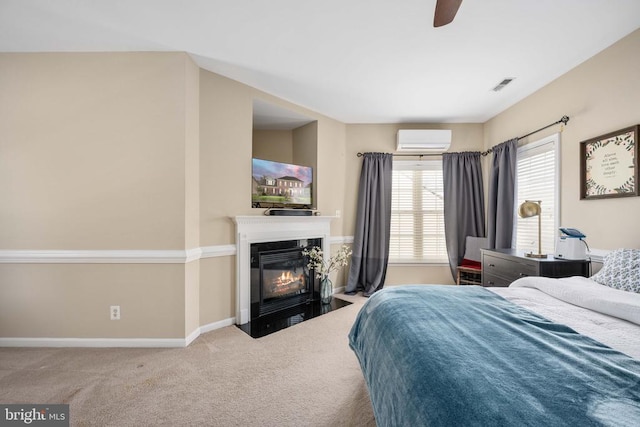 5819 Telluride Ln, Spotsylvania, VA 22553 - bedroom with a wall mounted AC, a fireplace with flush hearth, carpet floors, baseboards, and ceiling fan