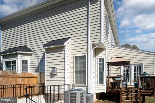 5819 Telluride Ln, Spotsylvania, VA 22553 - back of house featuring fence, a wooden deck, and central air condition unit