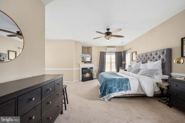 5819 Telluride Ln, Spotsylvania, VA 22553 - bedroom with light carpet, a wall mounted AC, a fireplace with flush hearth, a ceiling fan, and baseboards