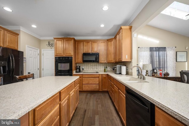5819 Telluride Ln, Spotsylvania, VA 22553 - kitchen featuring black appliances, a sink, light countertops, dark wood finished floors, and recessed lighting