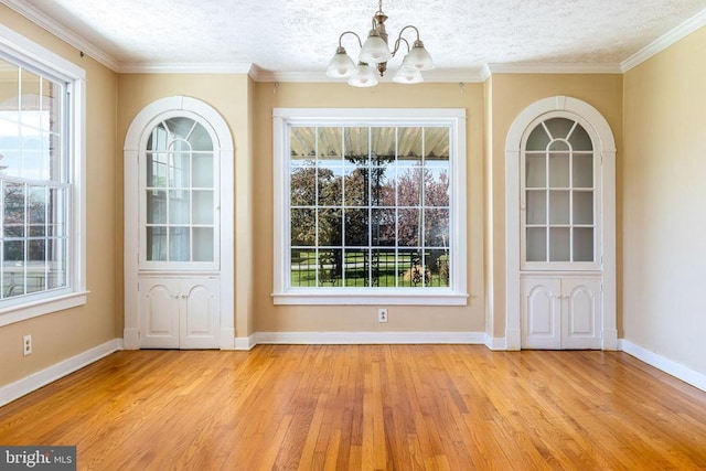 407 Kite Hollow Rd, Stanley, VA 22851 - unfurnished dining area featuring a chandelier, light wood-style flooring, healthy amount of natural light, a textured ceiling, and baseboards