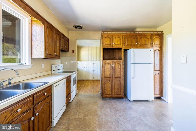 407 Kite Hollow Rd, Stanley, VA 22851 - kitchen with white appliances, a sink, brown cabinetry, and light countertops