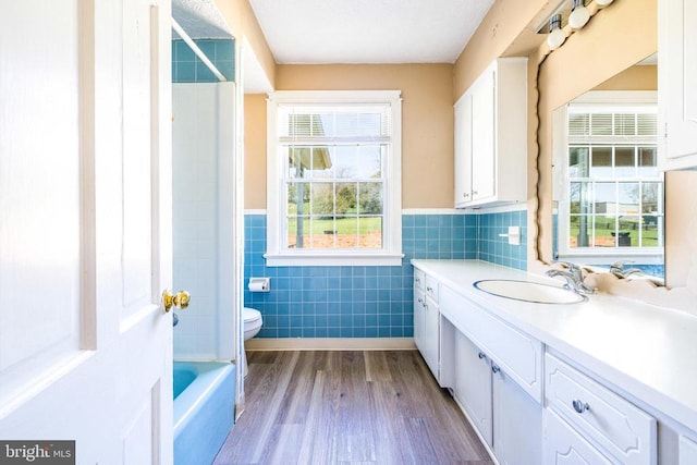 407 Kite Hollow Rd, Stanley, VA 22851 - bathroom with tile walls, vanity, toilet, a wainscoted wall, and wood finished floors