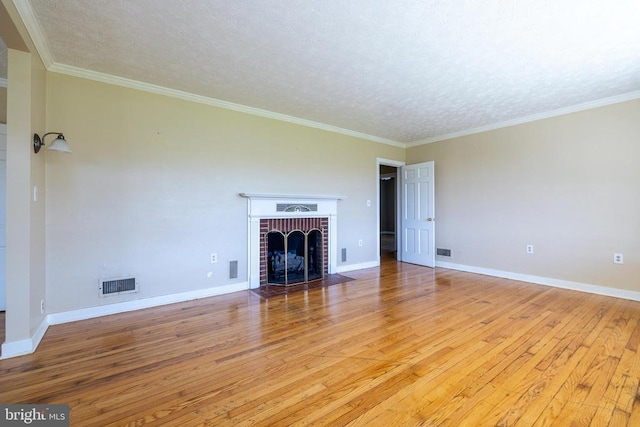 407 Kite Hollow Rd, Stanley, VA 22851 - unfurnished living room featuring light wood-style floors, a textured ceiling, a fireplace, baseboards, and crown molding