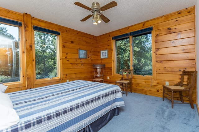 1003 Natural Chimneys Rd, Mount Solon, VA 22843 - bedroom with multiple windows, carpet flooring, wood walls, and a textured ceiling