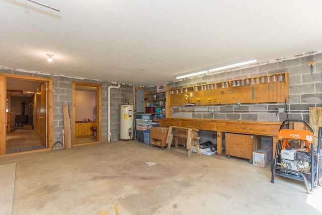 1003 Natural Chimneys Rd, Mount Solon, VA 22843 - garage with a workshop area, water heater, concrete block wall, and electric panel