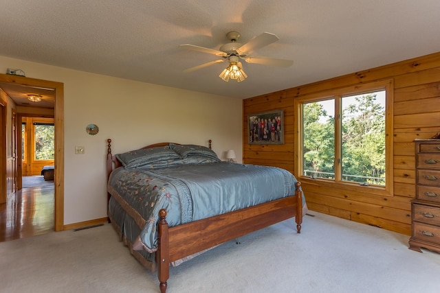 1003 Natural Chimneys Rd, Mount Solon, VA 22843 - bedroom with a ceiling fan, light carpet, and wood walls