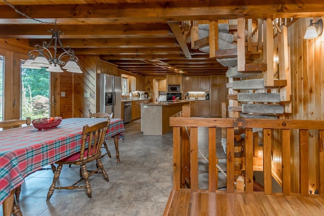 1003 Natural Chimneys Rd, Mount Solon, VA 22843 - dining space with a notable chandelier, wood walls, and beam ceiling