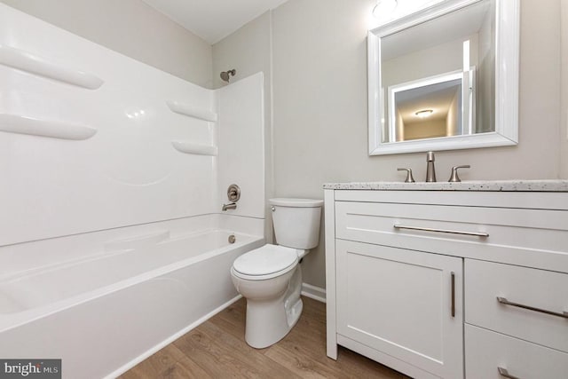 5907 Cambridge Dr, Fredericksburg, VA 22407 - full bath with wood finished floors, toilet, vanity, washtub / shower combination, and baseboards