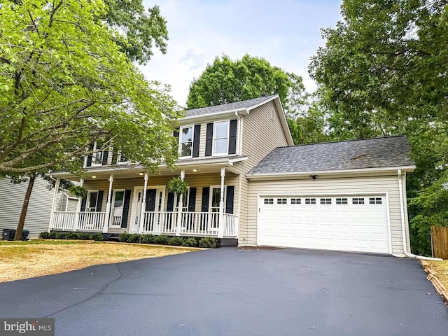 5907 Cambridge Dr, Fredericksburg, VA 22407 - view of front facade featuring asphalt driveway, a porch, a garage, and a shingled roof