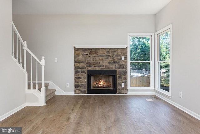 5907 Cambridge Dr, Fredericksburg, VA 22407 - unfurnished living room with wood finished floors, stairs, a fireplace, and baseboards