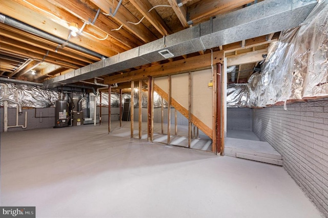 5907 Cambridge Dr, Fredericksburg, VA 22407 - unfinished below grade area with gas water heater and brick wall