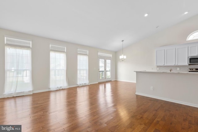 5910 Carnifex Ferry Rd W, Fredericksburg, VA 22407 - unfurnished living room with vaulted ceiling, dark wood-style floors, a chandelier, recessed lighting, and baseboards