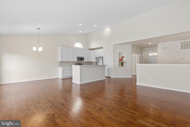 5910 Carnifex Ferry Rd W, Fredericksburg, VA 22407 - unfurnished living room featuring high vaulted ceiling, dark wood finished floors, a chandelier, baseboards, and recessed lighting