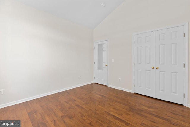 5910 Carnifex Ferry Rd W, Fredericksburg, VA 22407 - unfurnished bedroom with high vaulted ceiling, dark wood-style flooring, baseboards, and a closet