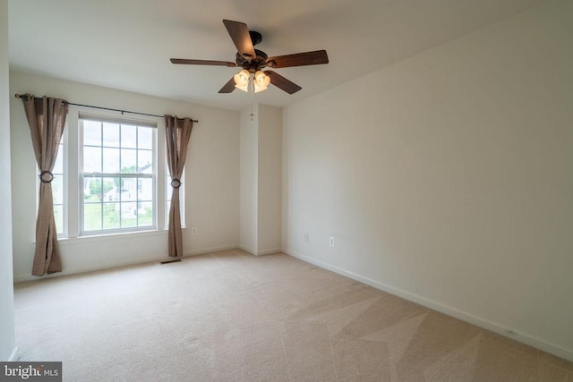 empty room featuring carpet floors, baseboards, and ceiling fan