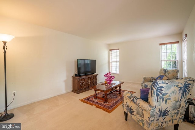 carpeted living room featuring plenty of natural light and baseboards