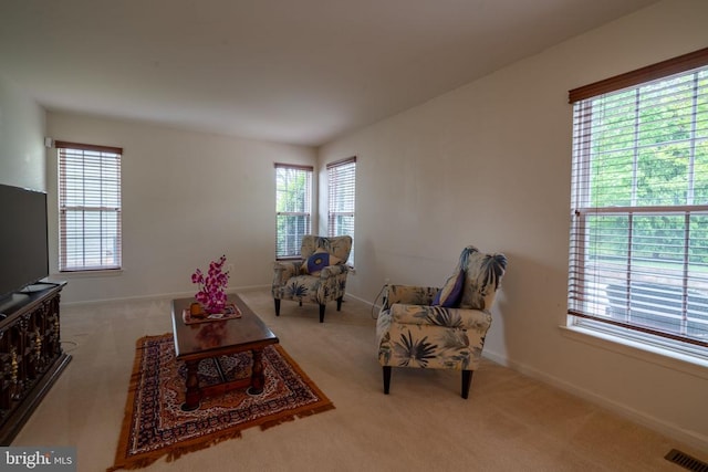 carpeted living room with baseboards