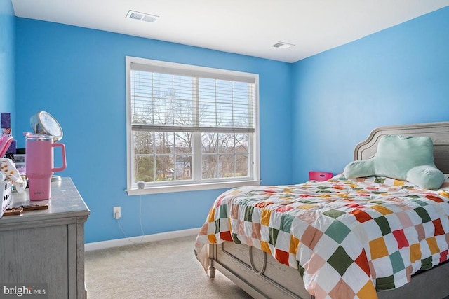 bedroom with baseboards, visible vents, and carpet