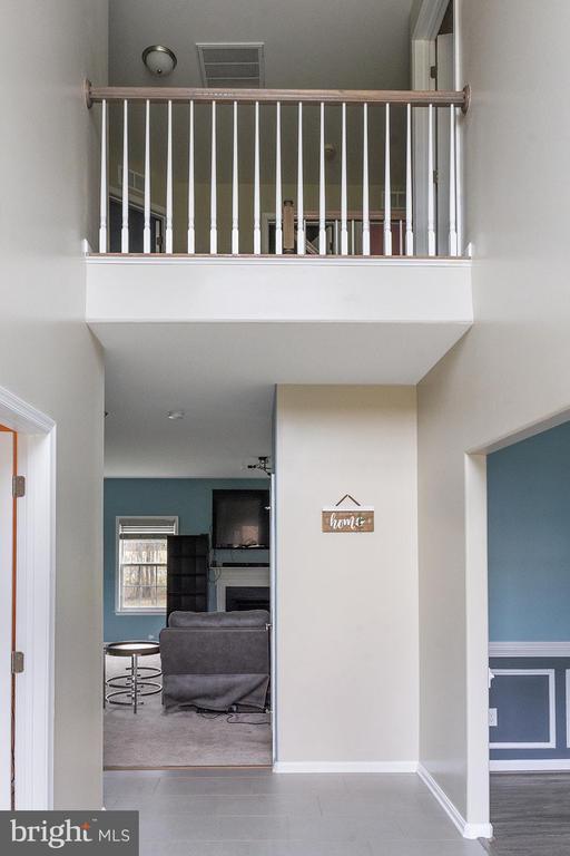 stairway with visible vents and a high ceiling