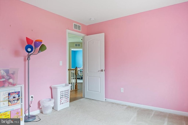 rec room featuring carpet flooring, baseboards, and visible vents