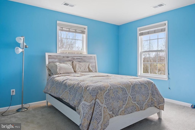 bedroom with carpet floors, baseboards, and visible vents