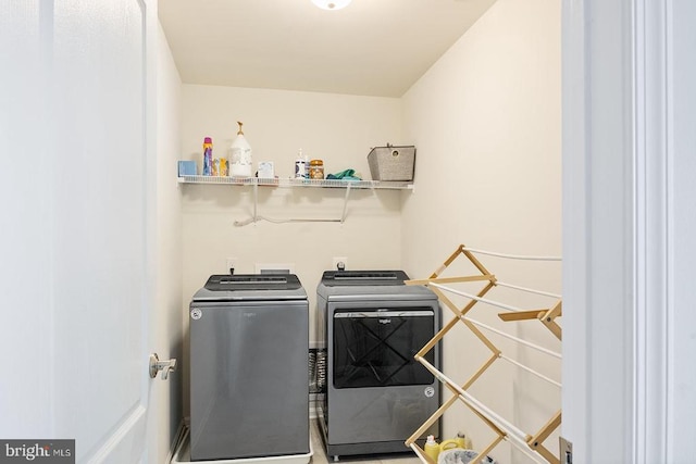 clothes washing area with washer and dryer and laundry area