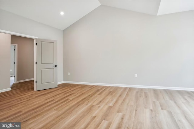  - unfurnished room featuring vaulted ceiling, light wood-style flooring, baseboards, and recessed lighting