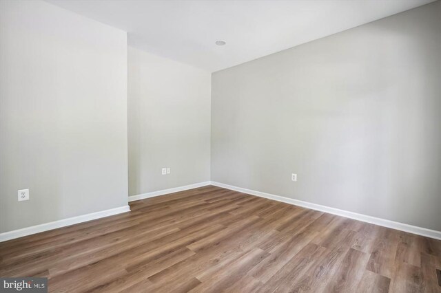  - empty room with wood finished floors and baseboards