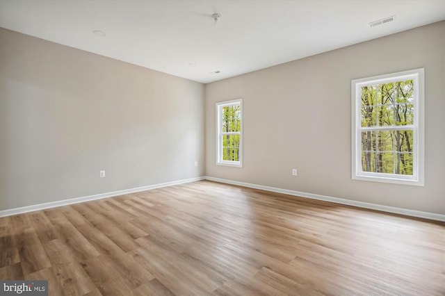  - spare room featuring baseboards, light wood-type flooring, and a pendent fire sprinkler