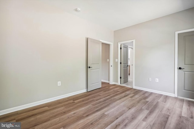  - unfurnished bedroom with light wood-type flooring and baseboards
