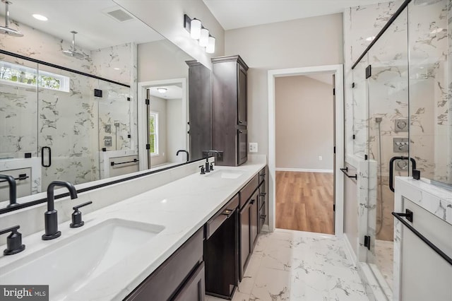  - full bathroom with a marble finish shower, marble finish floors, double vanity, and baseboards