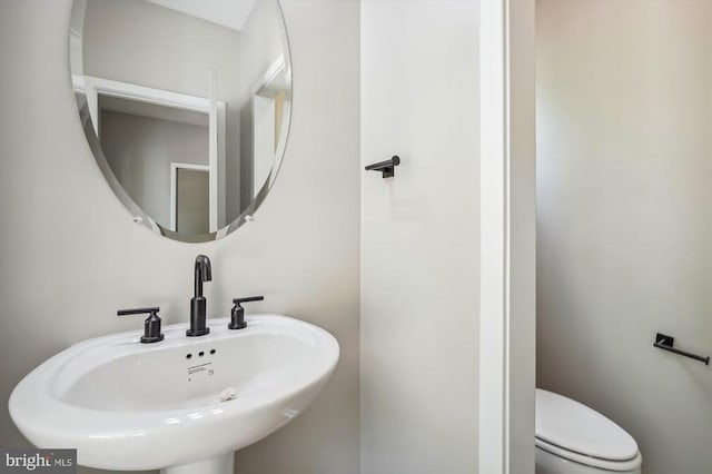  - half bath featuring a sink and toilet
